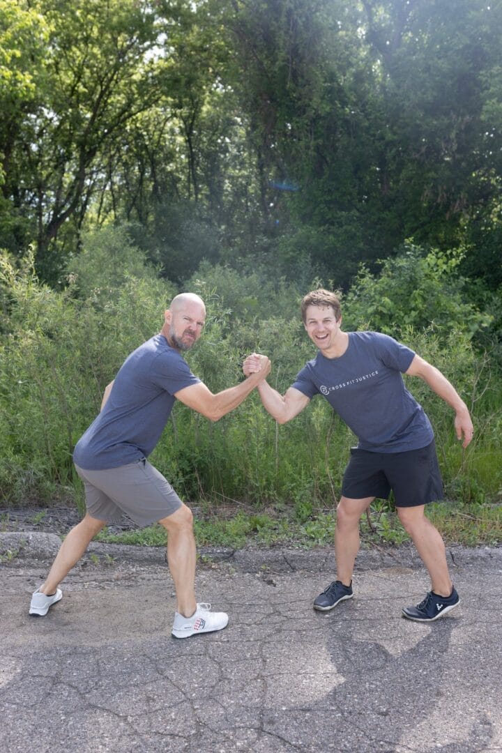 A coach guiding a first-time visitor through their CrossFit trial class in Milford.